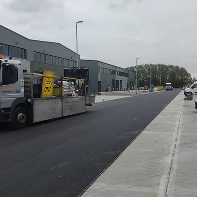 Line marking vehicle on a freshly surfaced commercial estate road