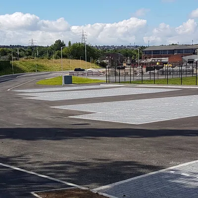 Completed commercial car park with freshly surfaced access routes and marked bays