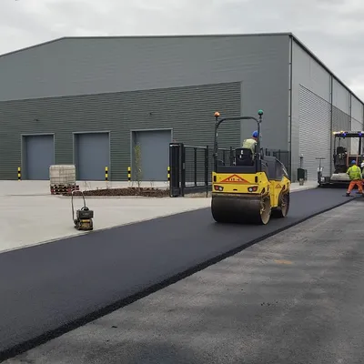 Roller compacting freshly laid asphalt on an industrial estate road